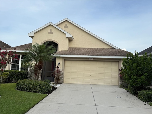 8301 Bridgeport Bay Cir, Mount Dora, FL 32757 - view of front of house featuring stucco siding, concrete driveway, a garage, stone siding, and a front yard