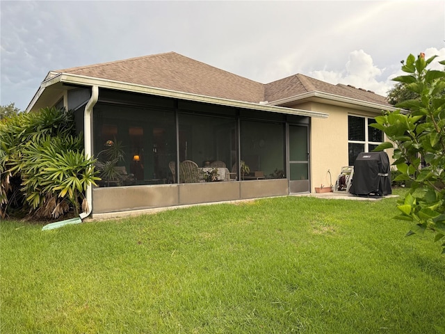 8301 Bridgeport Bay Cir, Mount Dora, FL 32757 - rear view of property featuring a sunroom, roof with shingles, and a lawn