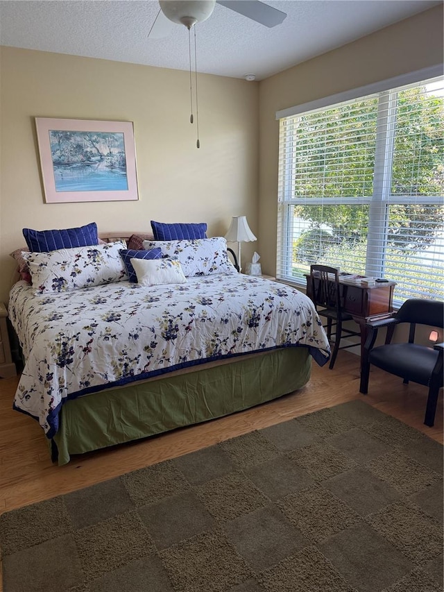 8301 Bridgeport Bay Cir, Mount Dora, FL 32757 - bedroom featuring wood finished floors and a ceiling fan