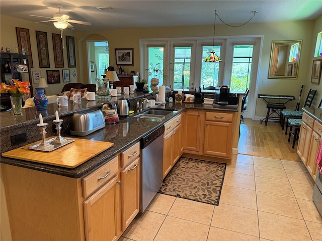 8301 Bridgeport Bay Cir, Mount Dora, FL 32757 - kitchen with stainless steel dishwasher, plenty of natural light, light tile patterned floors, and ceiling fan
