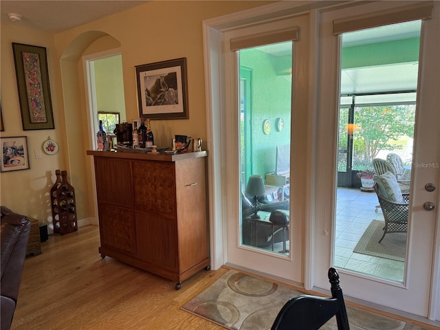 8301 Bridgeport Bay Cir, Mount Dora, FL 32757 - doorway with light wood-style flooring and arched walkways