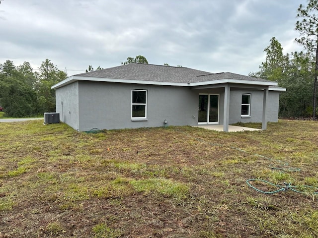 3838 W Baton Ln, Citrus Springs, FL 34433 - rear view of property with stucco siding, a patio, and a lawn