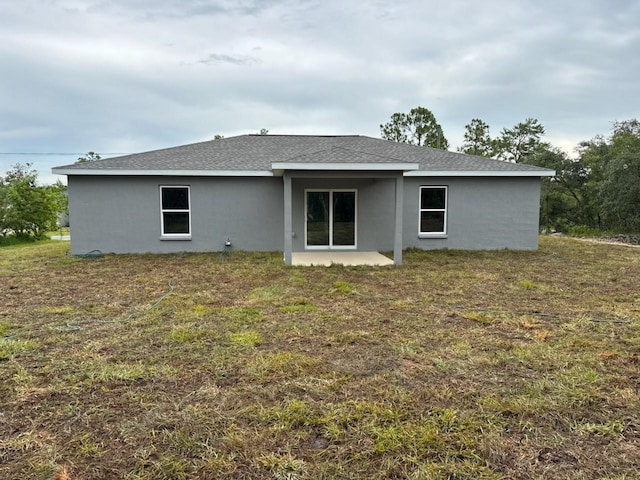 3838 W Baton Ln, Citrus Springs, FL 34433 - back of property featuring stucco siding and a lawn