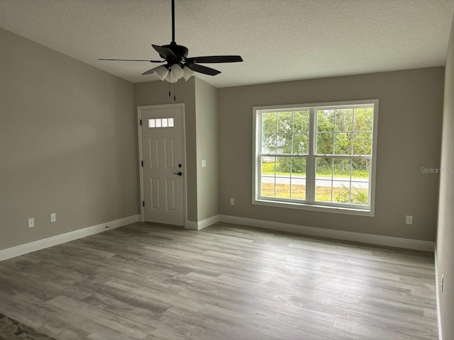 3838 W Baton Ln, Citrus Springs, FL 34433 - entrance foyer with a textured ceiling, wood finished floors, and a ceiling fan