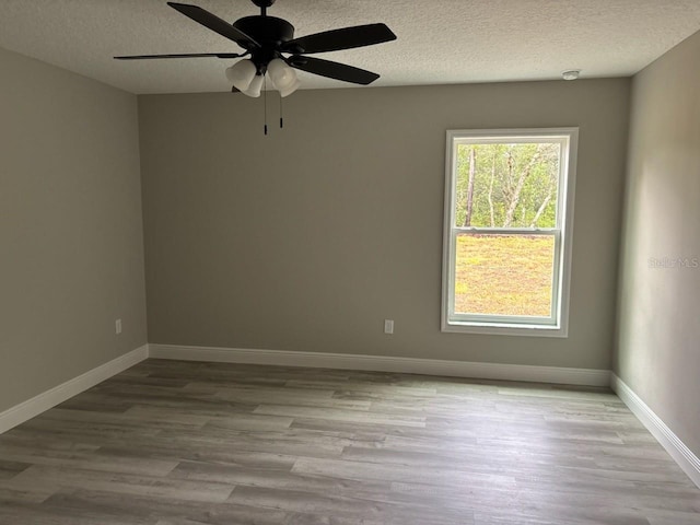 3838 W Baton Ln, Citrus Springs, FL 34433 - spare room featuring a textured ceiling, wood finished floors, and a ceiling fan