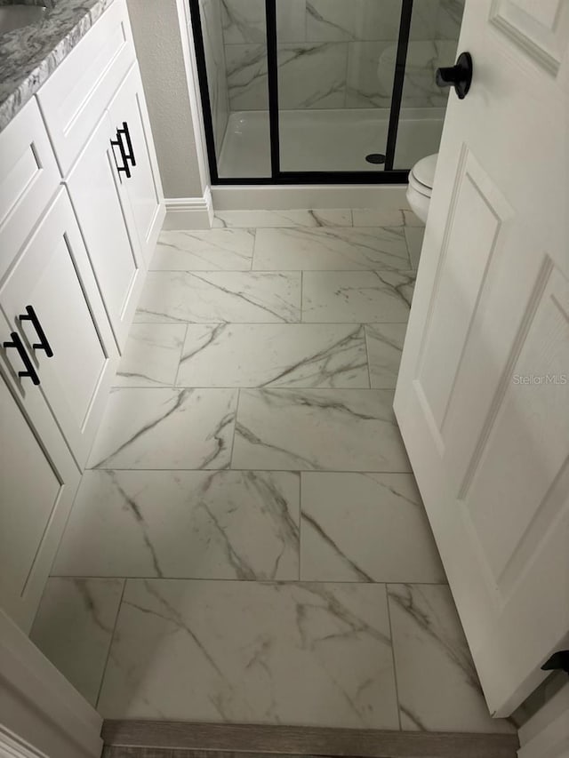 3838 W Baton Ln, Citrus Springs, FL 34433 - full bathroom with marble finish floors, a marble finish shower, and vanity