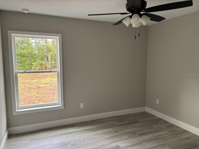 3838 W Baton Ln, Citrus Springs, FL 34433 - unfurnished room featuring wood finished floors, a smoke detector, ceiling fan, and a textured ceiling