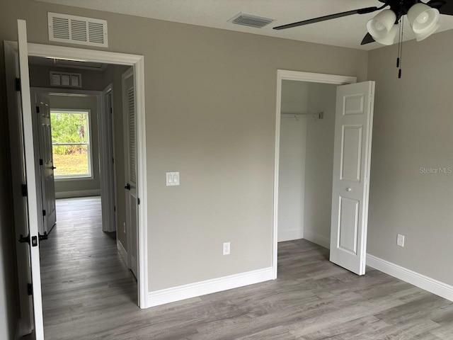 3838 W Baton Ln, Citrus Springs, FL 34433 - unfurnished bedroom with wood finished floors, a closet, and a ceiling fan