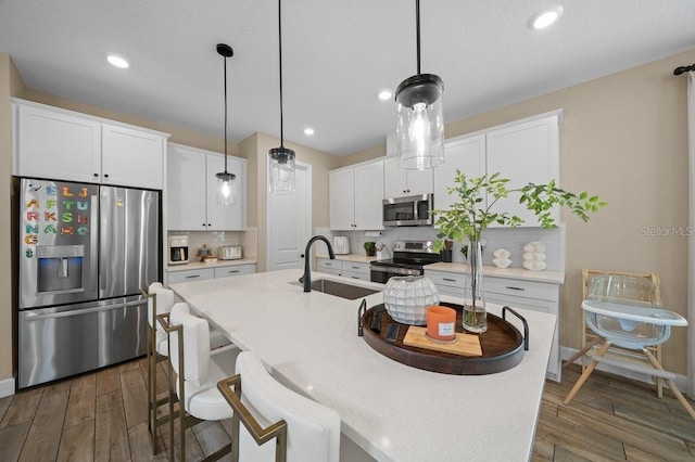 3916 Southern Vista Loop, Saint Cloud, FL 34772 - kitchen featuring stainless steel appliances, tasteful backsplash, dark wood-style floors, white cabinetry, and recessed lighting