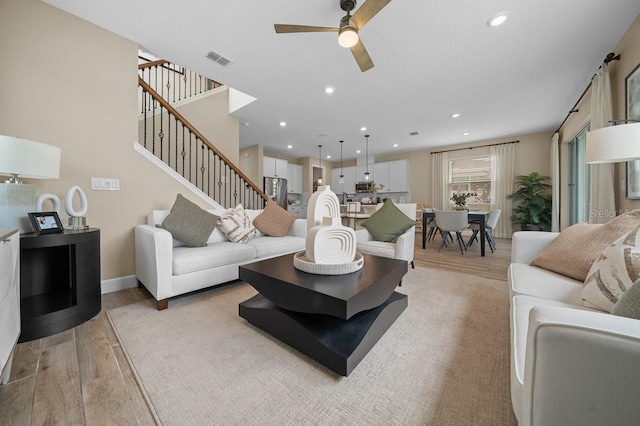 3916 Southern Vista Loop, Saint Cloud, FL 34772 - living room featuring light wood finished floors, ceiling fan, stairway, and recessed lighting