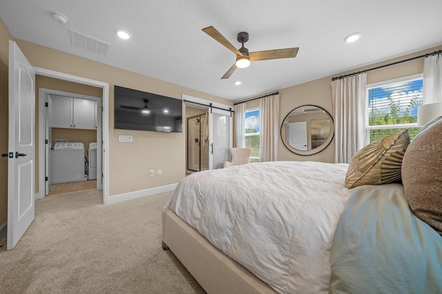 3916 Southern Vista Loop, Saint Cloud, FL 34772 - bedroom with washer and dryer, light carpet, a barn door, a ceiling fan, and recessed lighting