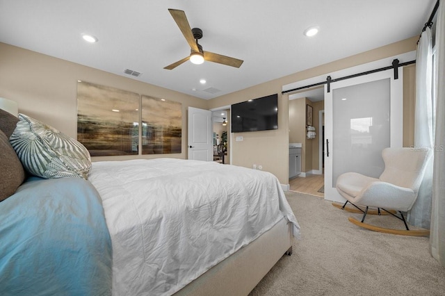 3916 Southern Vista Loop, Saint Cloud, FL 34772 - bedroom with a barn door, ensuite bath, ceiling fan, and recessed lighting