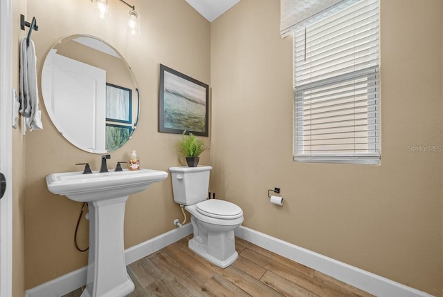 3916 Southern Vista Loop, Saint Cloud, FL 34772 - half bath featuring wood finished floors and toilet