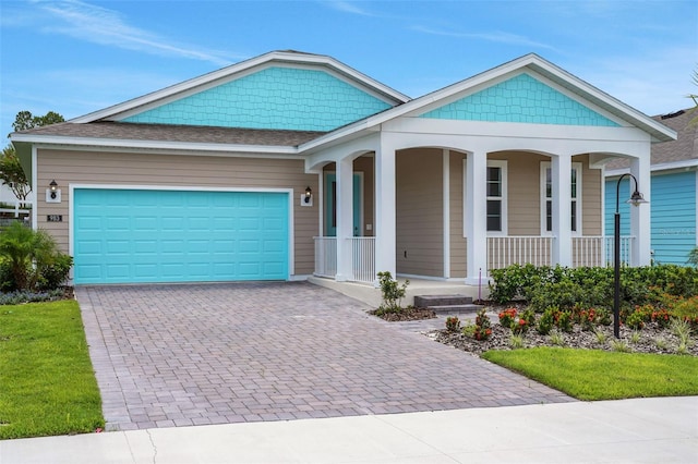 983 Fiesta Key Cir, Lady Lake, FL 32159 - view of front of home featuring a porch, decorative driveway, an attached garage, and roof with shingles