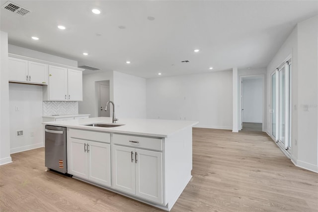 983 Fiesta Key Cir, Lady Lake, FL 32159 - kitchen featuring stainless steel dishwasher, light wood finished floors, an island with sink, white cabinetry, and recessed lighting