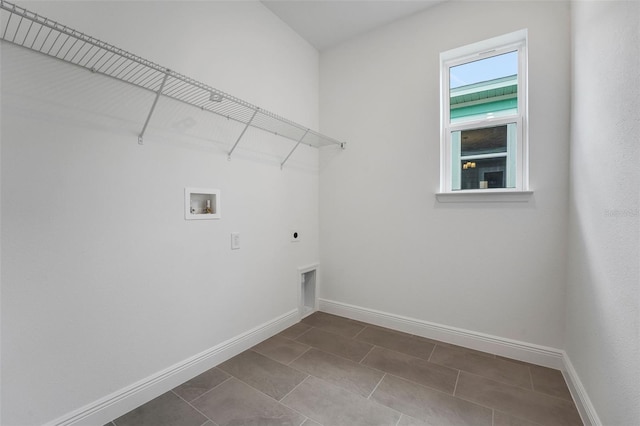 983 Fiesta Key Cir, Lady Lake, FL 32159 - laundry area with electric dryer hookup, washer hookup, and dark tile patterned flooring