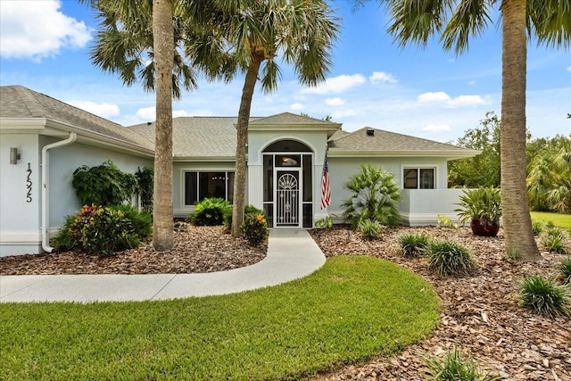 17525 SE 111th Cir, Summerfield, FL 34491 - ranch-style home featuring stucco siding, a front yard, and roof with shingles