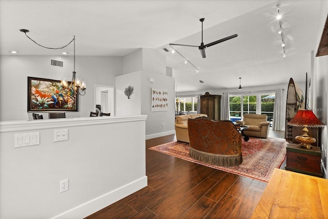 17525 SE 111th Cir, Summerfield, FL 34491 - living area with rail lighting, dark wood-style flooring, a ceiling fan, a chandelier, and lofted ceiling