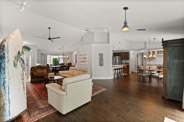 17525 SE 111th Cir, Summerfield, FL 34491 - living area featuring rail lighting, a chandelier, dark wood-style flooring, ceiling fan, and high vaulted ceiling