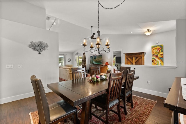 17525 SE 111th Cir, Summerfield, FL 34491 - dining area featuring a chandelier, dark wood-style flooring, vaulted ceiling, and track lighting