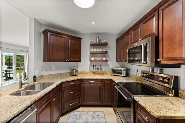 17525 SE 111th Cir, Summerfield, FL 34491 - kitchen featuring stainless steel appliances, open shelves, light stone countertops, and light tile patterned floors