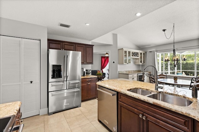 17525 SE 111th Cir, Summerfield, FL 34491 - kitchen featuring stainless steel appliances, lofted ceiling, a chandelier, glass insert cabinets, and light tile patterned floors