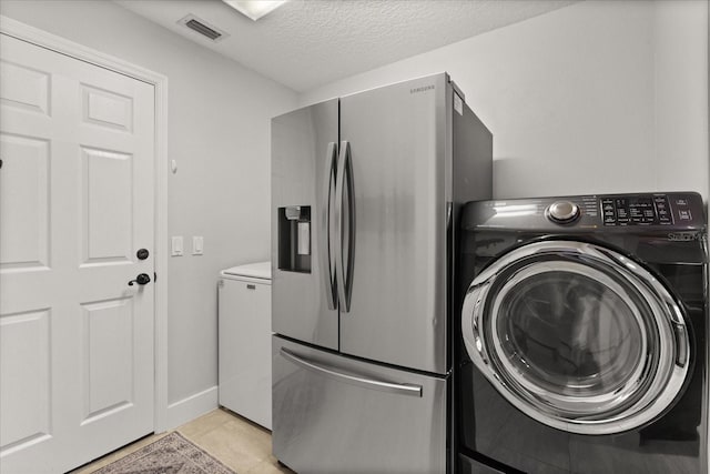 17525 SE 111th Cir, Summerfield, FL 34491 - laundry room with washer and dryer, a textured ceiling, and light tile patterned flooring