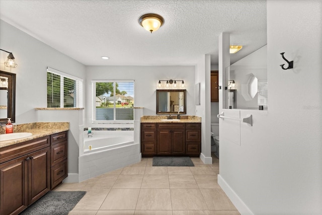 17525 SE 111th Cir, Summerfield, FL 34491 - bathroom featuring a bath, two vanities, a textured ceiling, and tile patterned floors