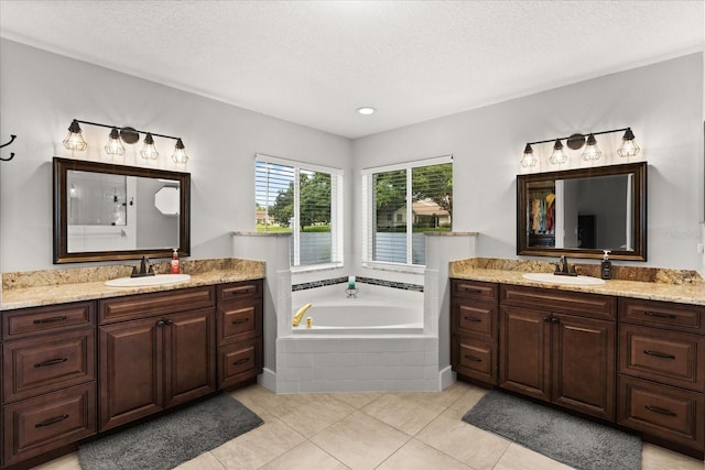 17525 SE 111th Cir, Summerfield, FL 34491 - full bath with two vanities, a garden tub, tile patterned floors, recessed lighting, and a textured ceiling