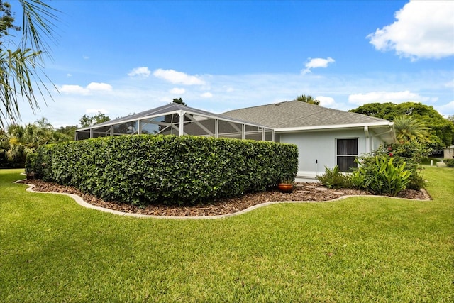 17525 SE 111th Cir, Summerfield, FL 34491 - rear view of house with a lawn, a lanai, and a shingled roof