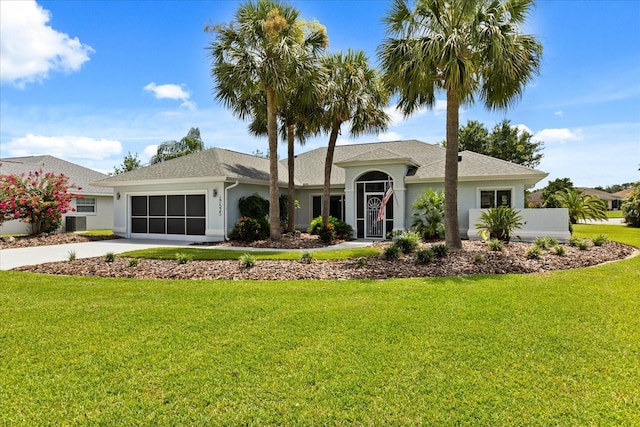 17525 SE 111th Cir, Summerfield, FL 34491 - single story home with stucco siding, a garage, concrete driveway, and a front yard