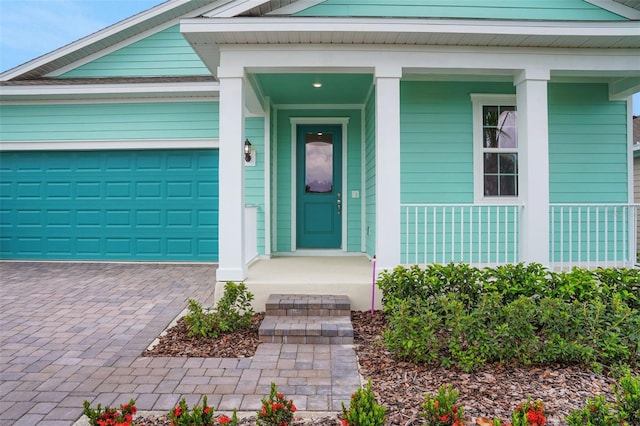 985 Fiesta Key Cir, Lady Lake, FL 32159 - entrance to property with decorative driveway, an attached garage, and covered porch