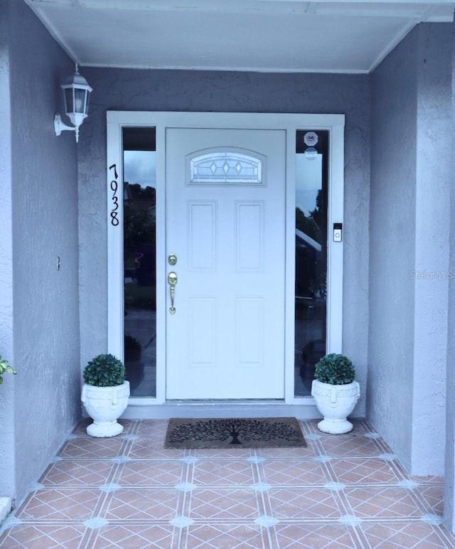 7938 Tumblestone Dr, Orlando, FL 32819 - view of exterior entry featuring stucco siding