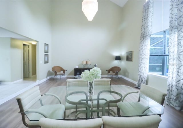 7938 Tumblestone Dr, Orlando, FL 32819 - dining space featuring a towering ceiling and wood finished floors