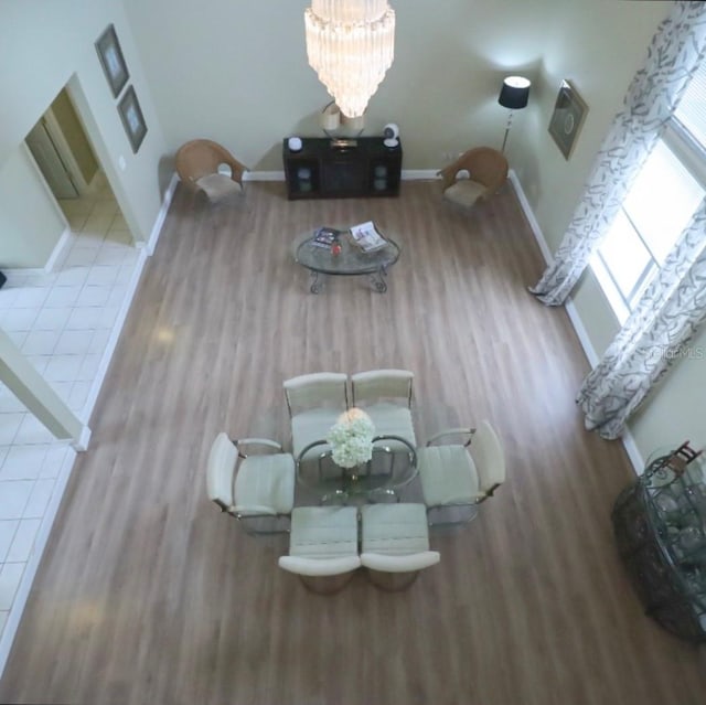 7938 Tumblestone Dr, Orlando, FL 32819 - unfurnished dining area featuring wood finished floors and a chandelier