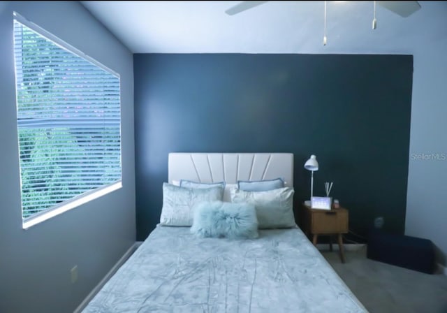7938 Tumblestone Dr, Orlando, FL 32819 - bedroom featuring multiple windows and a ceiling fan