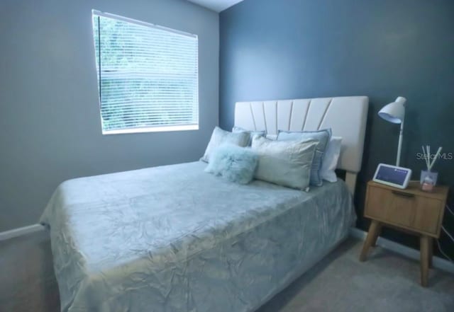 7938 Tumblestone Dr, Orlando, FL 32819 - carpeted bedroom featuring multiple windows