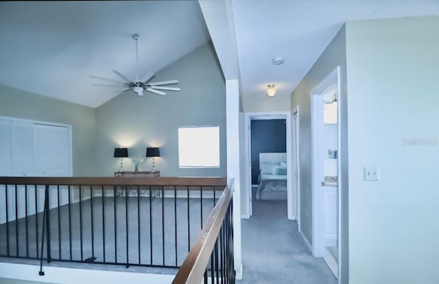 7938 Tumblestone Dr, Orlando, FL 32819 - hallway with carpet, vaulted ceiling, and an upstairs landing