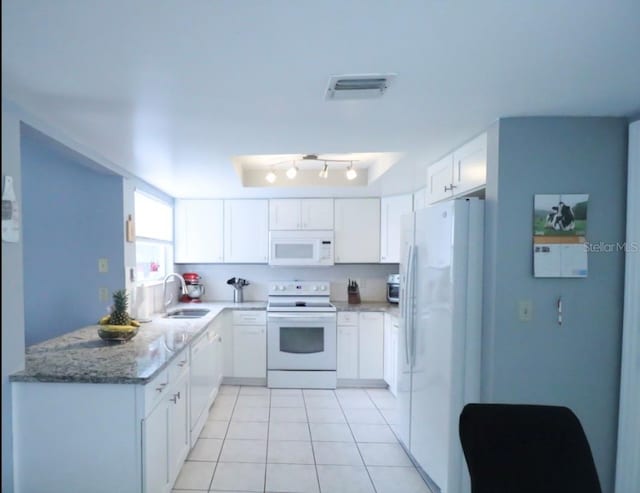 7938 Tumblestone Dr, Orlando, FL 32819 - kitchen with white appliances, white cabinetry, light tile patterned flooring, and light stone countertops