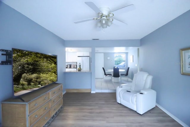 7938 Tumblestone Dr, Orlando, FL 32819 - sitting room featuring a ceiling fan and wood finished floors