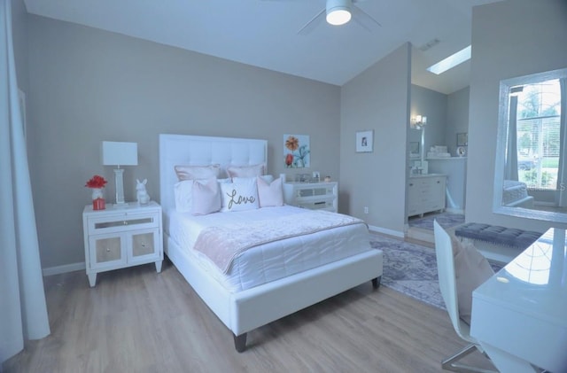7938 Tumblestone Dr, Orlando, FL 32819 - bedroom featuring wood finished floors, vaulted ceiling, ceiling fan, a skylight, and ensuite bathroom