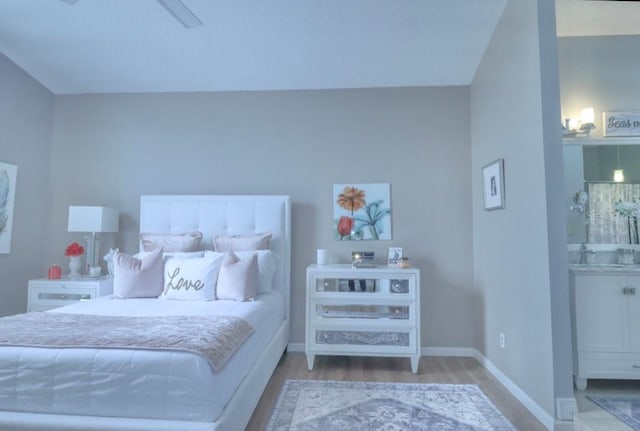 7938 Tumblestone Dr, Orlando, FL 32819 - bedroom featuring wood finished floors and baseboards