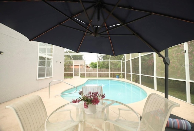 7938 Tumblestone Dr, Orlando, FL 32819 - view of swimming pool with a fenced backyard, glass enclosure, and a patio area