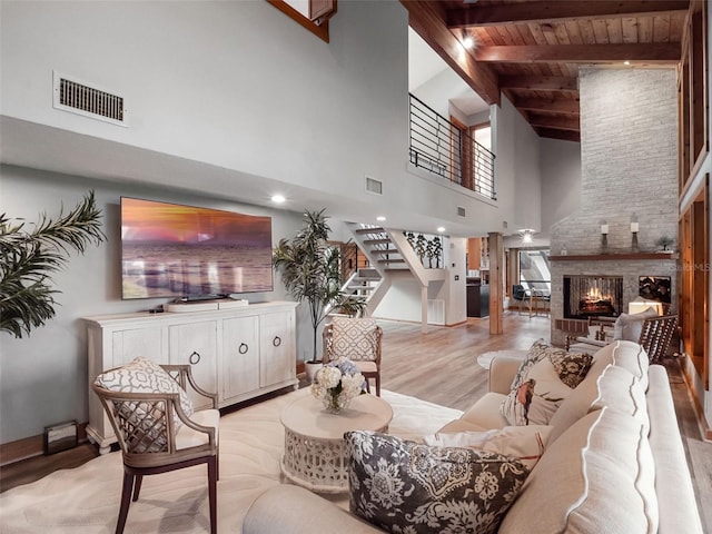 1978 Brantley Cir, Clermont, FL 34711 - living area featuring stairway, light wood-style floors, high vaulted ceiling, a fireplace, and a wooden ceiling with exposed beams