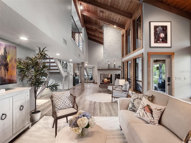 1978 Brantley Cir, Clermont, FL 34711 - living area featuring a wooden ceiling with exposed beams, wood finished floors, stairs, high vaulted ceiling, and a multi sided fireplace