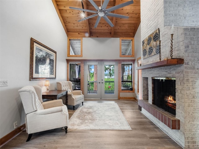 1978 Brantley Cir, Clermont, FL 34711 - living room featuring high vaulted ceiling, a brick fireplace, ceiling fan, french doors, and wood finished floors
