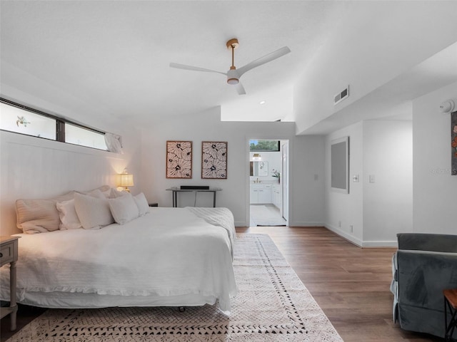 1978 Brantley Cir, Clermont, FL 34711 - bedroom featuring light wood-type flooring, ensuite bathroom, vaulted ceiling, and a ceiling fan