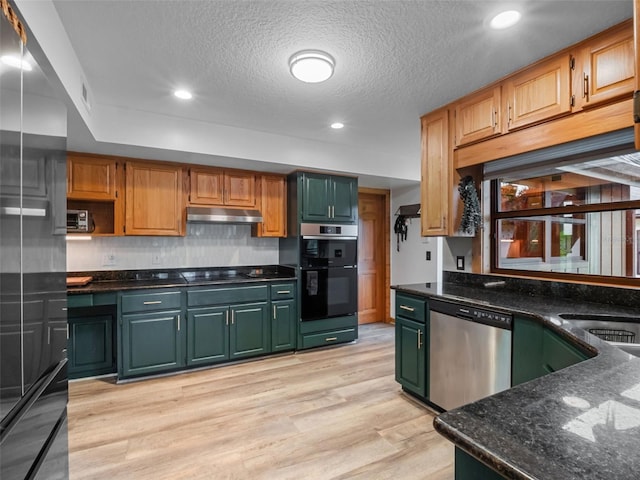 1978 Brantley Cir, Clermont, FL 34711 - kitchen with black appliances, green cabinetry, under cabinet range hood, light wood-type flooring, and dark stone countertops