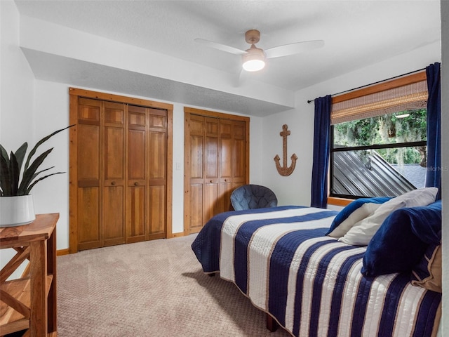 1978 Brantley Cir, Clermont, FL 34711 - bedroom featuring light colored carpet, two closets, and ceiling fan