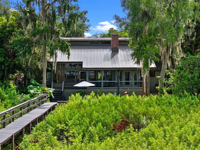 1978 Brantley Cir, Clermont, FL 34711 - rear view of property with a chimney and stairway